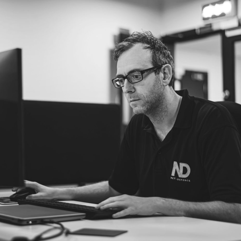 IT Manager on his laptop at a desk