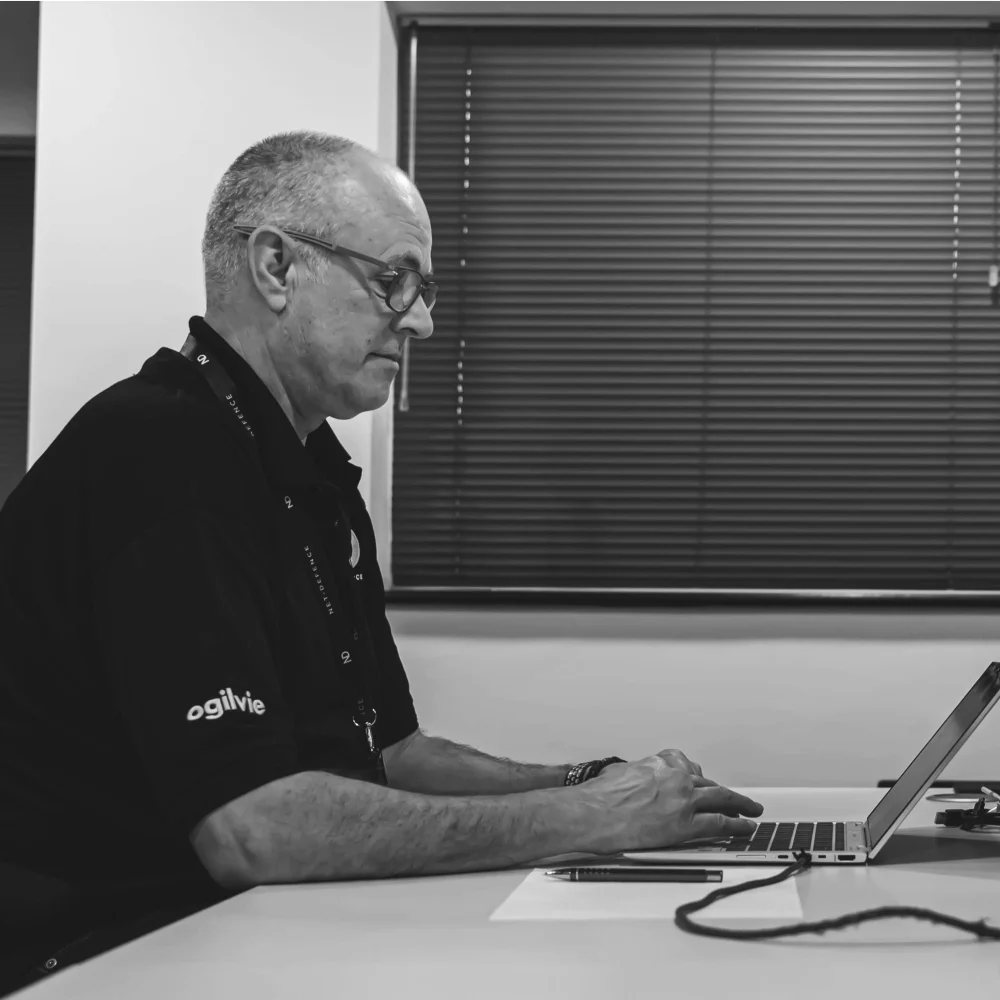 Craig Hester on laptop in ND office
