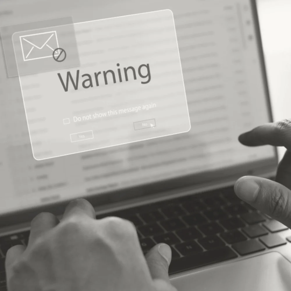 Warning pop up for phishing email appearing on laptop.