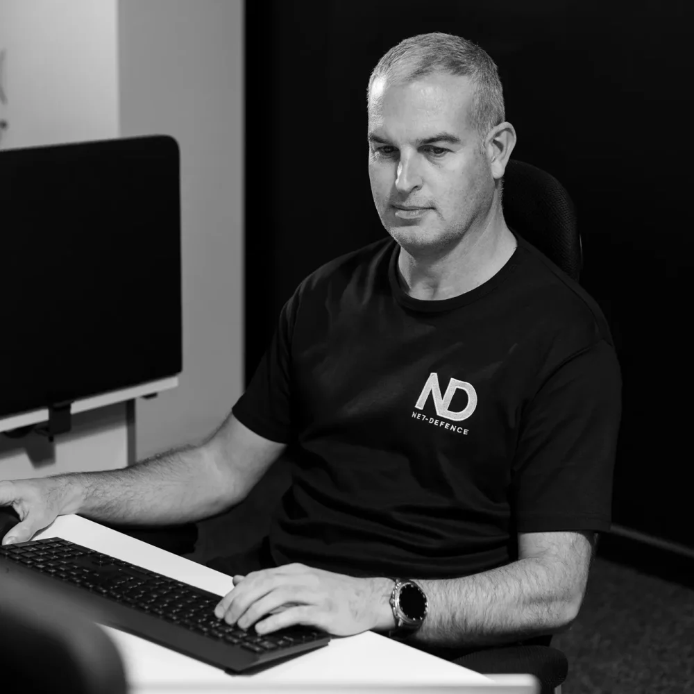 Simon Richardson form Net-defence working on his computer.